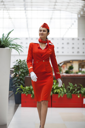 RUSSIA, MOSCOW: 28 JUNE 2019. Beautiful stewardess dressed in official red uniform of Aeroflot Airlines on airportのeditorial素材