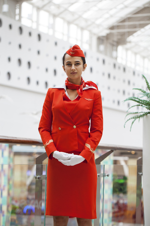 RUSSIA, MOSCOW: 28 JUNE 2019. Beautiful stewardess dressed in official red uniform of Aeroflot Airlines on airportのeditorial素材