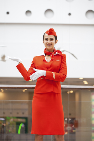 RUSSIA, MOSCOW: 28 JUNE 2019. Beautiful stewardess dressed in official red uniform of Aeroflot Airlines on airportのeditorial素材