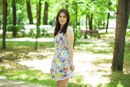Close up portrait of beautiful young happy brunette woman sexy dress, summer park outdoorsの写真素材
