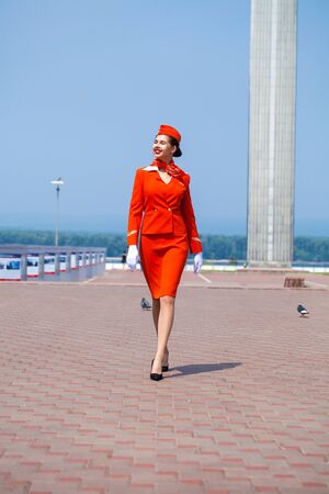 RUSSIA, SAMARA: 26 JULE 2019. Beautiful stewardess dressed in official red uniform of Aeroflot Airlines, Summer Samara outdoorsの写真素材