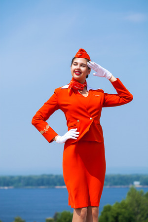 RUSSIA, SAMARA: 26 JULE 2019. Beautiful stewardess dressed in official red uniform of Aeroflot Airlines, Summer Samara outdoorsのeditorial素材