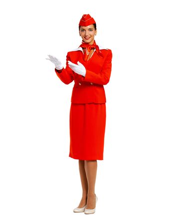 Close up portrait of a young beautiful Russian stewardess in red uniform - isolated on white backgroundの写真素材