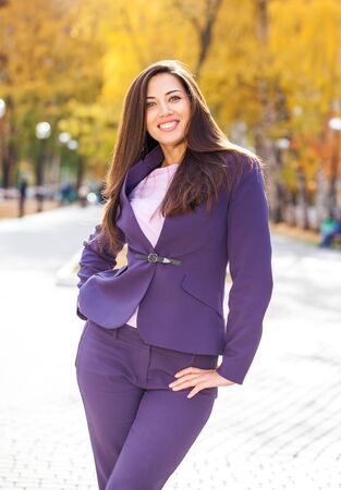 Young business woman in autumn parkの写真素材
