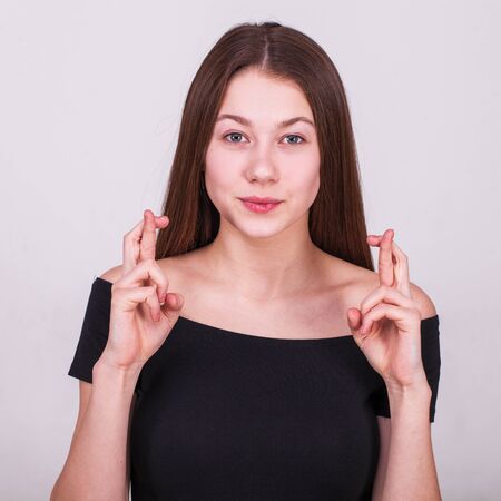 Close up portrait of a young beautiful brunette model isolated on gray background