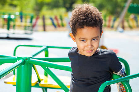 Close up portrait of little boy in autumn parkの写真素材