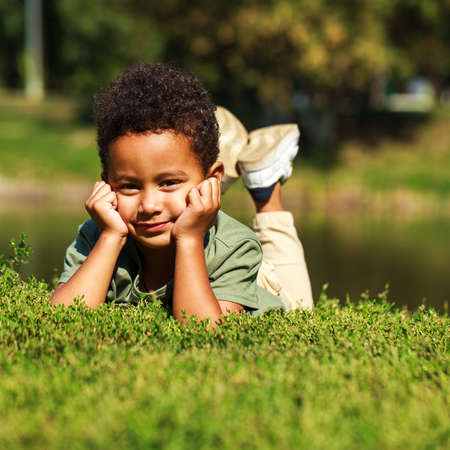 Close up portrait of little boy in autumn parkの写真素材