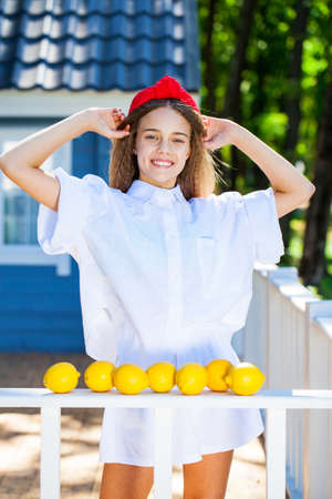 Portrait of a young teenage girl with lemonsの写真素材