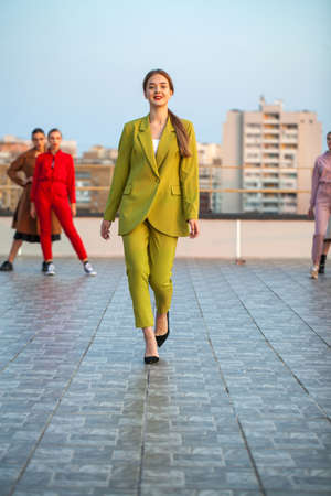 close up portrait of a young beautiful blonde woman in blouse and white shorts, summer park outdoorの写真素材