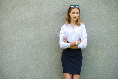 Portrait of a young girl in a white ball gown posing against the background of the Orthodox Cathedralの写真素材