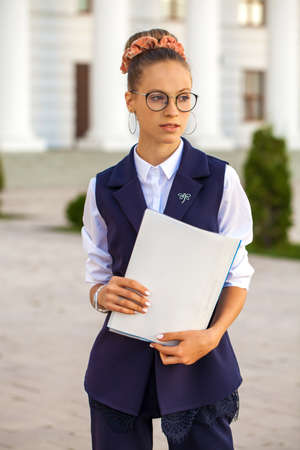 Blond elegant successful business girl in white shirt to go and touch pad during a break sitting...