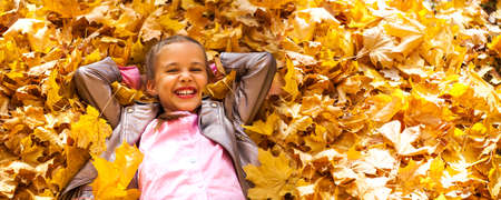 Portrait of a young girl in an autumn park