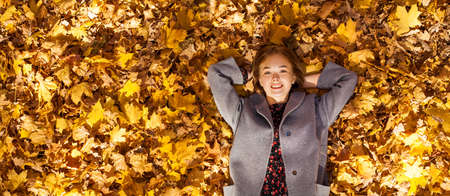 Full body portrait of a young beautiful girl in an autumn park