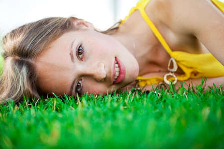 Close up portrait of a young beautiful blonde woman, summer outdoorsの写真素材