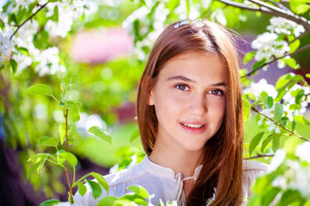 Close up portrait of a young beautiful brunette woman in yellow blouse