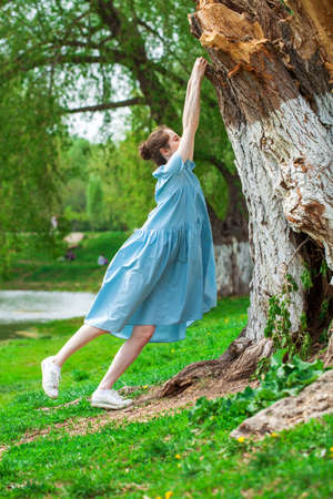 Full length portrait of young beautiful brunette woman in pink dressの写真素材