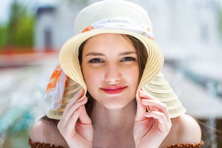 Young beautiful girl with a book resting in a summer park