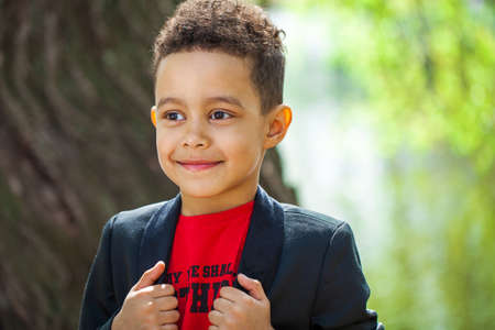 Five year old little boy in a summer parkの写真素材