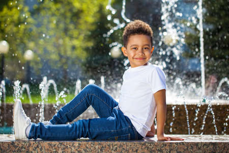 Five year old little boy in a summer parkの写真素材