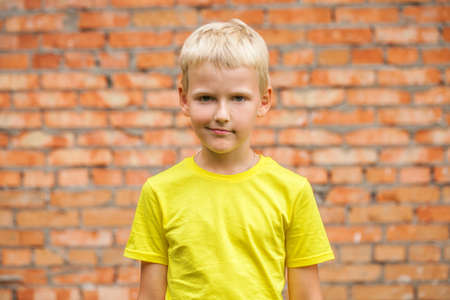 Close-up portrait of a little boy in a summer parkの写真素材