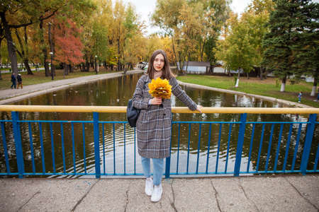 Portrait of a young beautiful brown-haired girl with freckles on her faceの写真素材