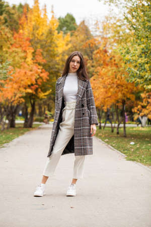 Portrait of a young beautiful brown-haired girl with freckles on her faceの写真素材