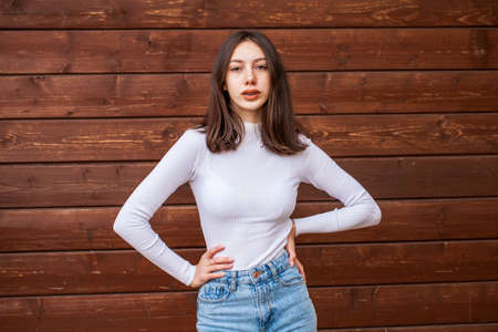 Portrait of a young beautiful brown-haired girl with freckles on her faceの写真素材