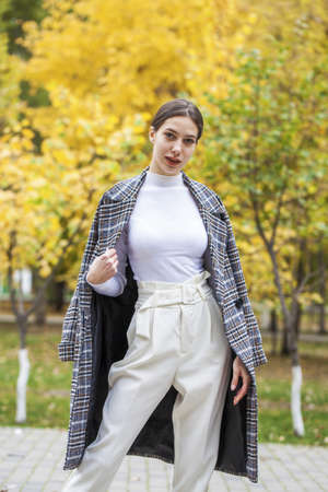 Portrait of a young beautiful brown-haired girl with freckles on her faceの写真素材