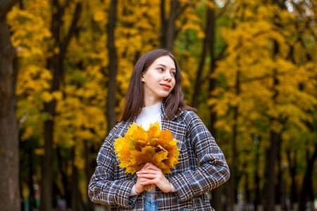 Portrait of a young beautiful brown-haired girl with freckles on her faceの写真素材