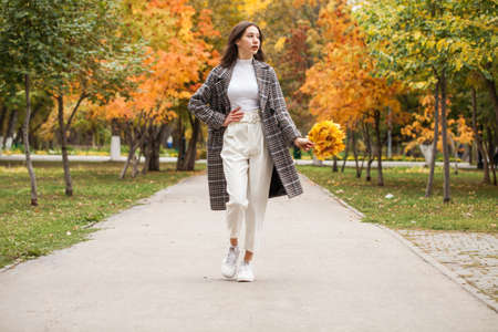 Portrait of a young beautiful brown-haired girl with freckles on her faceの写真素材