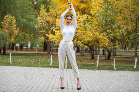 Portrait of a young beautiful brown-haired girl with freckles on her faceの写真素材