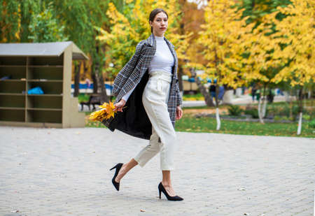 Portrait of a young beautiful brown-haired girl with freckles on her faceの写真素材