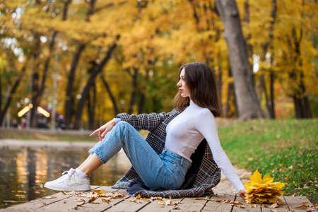 Portrait of a young beautiful brown-haired girl with freckles on her faceの写真素材