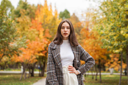 Portrait of a young beautiful brown-haired girl with freckles on her faceの写真素材