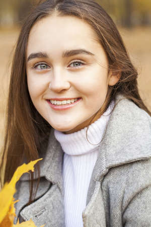 Full body portrait of a young beautiful brunette model, isolated on gray backgroundの写真素材