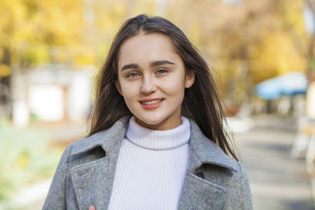 Full body portrait of a young beautiful brunette model, isolated on gray backgroundの写真素材