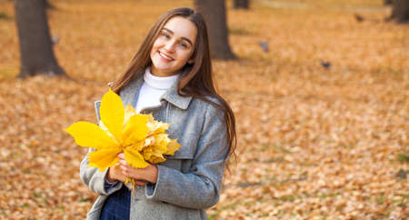 Full body portrait of a young beautiful brunette model, isolated on gray background