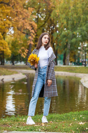 Portrait of a young beautiful brown-haired girl with freckles on her faceの写真素材
