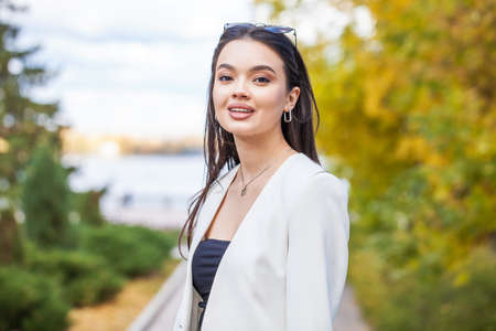 Close up portrait of a young beautiful brunette woman in winter parkの写真素材