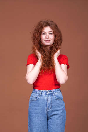 Hair beauty. Portrait of a young beautiful red hair womanの写真素材