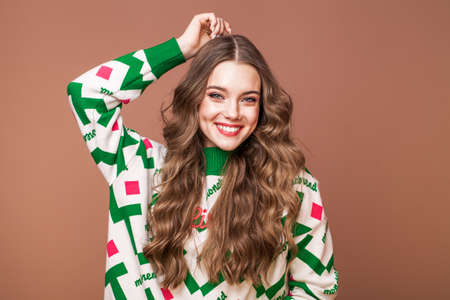 Studio portrait of a young beautiful teenage girl on a beige background