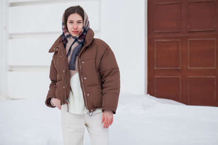 Full length portrait of young beautiful girl posing in winter parkの写真素材