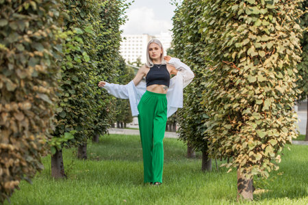 Portrait of a young beautiful blonde woman in a stylish spotted summer suitの写真素材