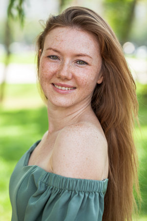Portrait of a red-haired young woman in yellow dress