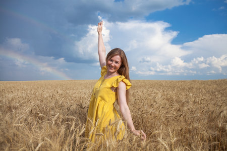 Portrait of a red-haired young woman in yellow dressの写真素材