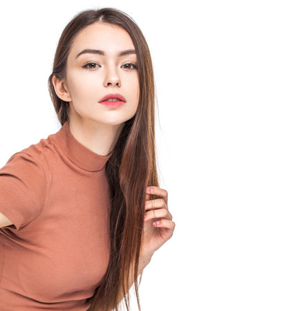 Portrait of a young beautiful girl in a red coatの写真素材