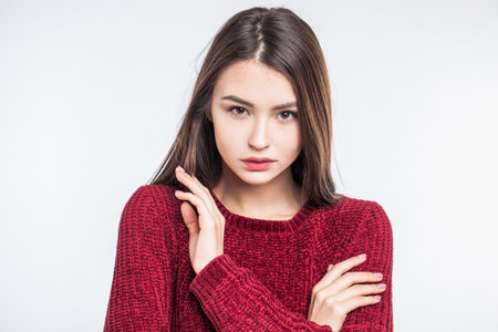 Portrait of a young beautiful girl in a red coatの写真素材