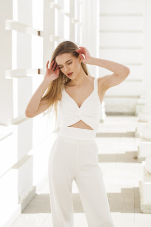 Portrait of a young beautiful blonde woman in a beige jacketの写真素材