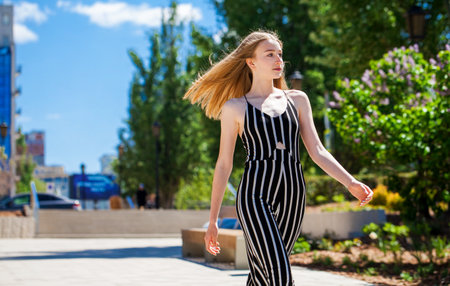 Portrait of a young beautiful blonde girl in clothes with bare shouldersの写真素材