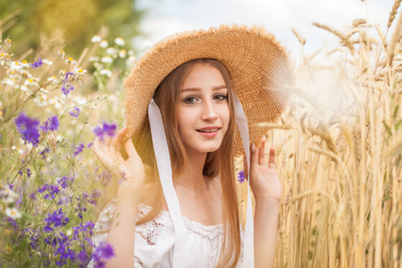 portrait of a young blonde model in wheat fieldの写真素材